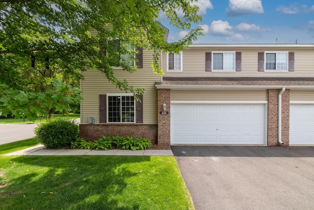 451 Frederick Cir Unit 1405, Hastings, MN 55033 - view of front of home featuring brick siding, driveway, a front lawn, and a garage