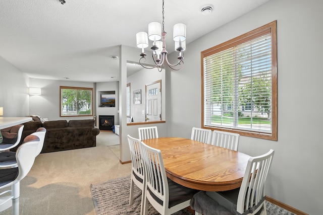 451 Frederick Cir Unit 1405, Hastings, MN 55033 - dining room with carpet floors, a chandelier, and a warm lit fireplace