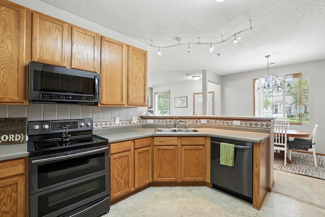 451 Frederick Cir Unit 1405, Hastings, MN 55033 - kitchen featuring appliances with stainless steel finishes, a peninsula, tasteful backsplash, a textured ceiling, and a chandelier