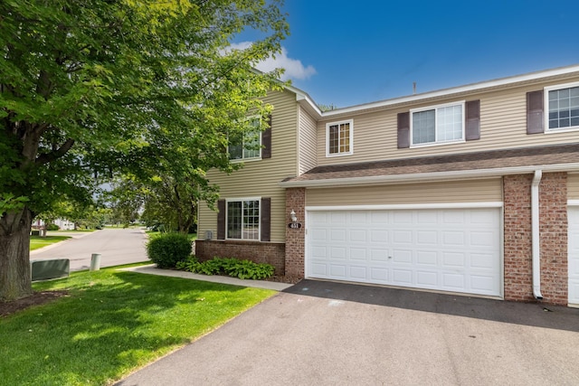 451 Frederick Cir Unit 1405, Hastings, MN 55033 - view of front of house with brick siding, driveway, a front lawn, and an attached garage