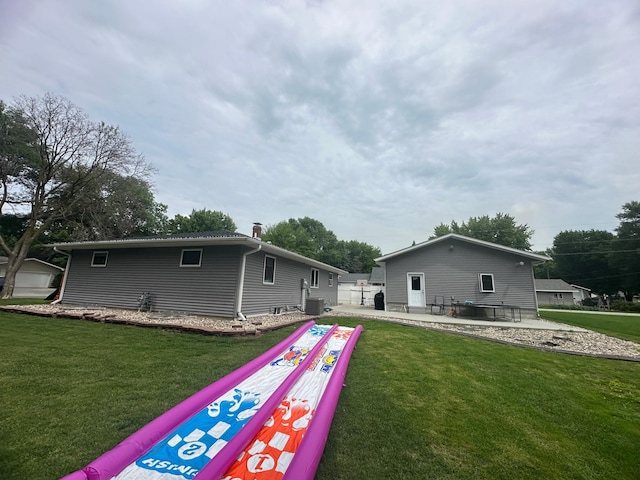 1520 6th St, Montevideo, MN 56265 - rear view of property featuring a lawn and a patio