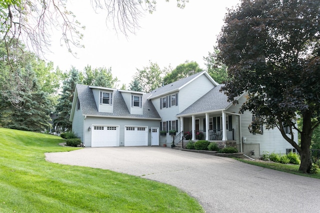 6045 Galpin Lake Rd, Shorewood, MN 55331 - view of front of home with covered porch, asphalt driveway, a garage, a front lawn, and a shingled roof