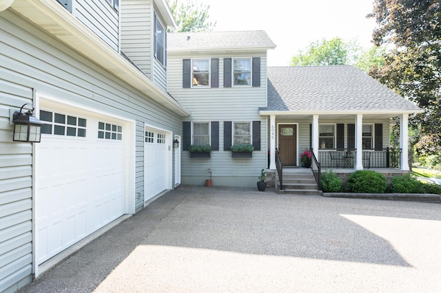 6045 Galpin Lake Rd, Shorewood, MN 55331 - view of front of property with a garage, driveway, covered porch, and roof with shingles
