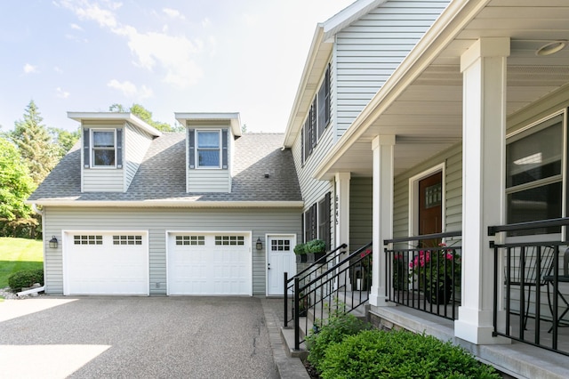 6045 Galpin Lake Rd, Shorewood, MN 55331 - view of front of house with a shingled roof, asphalt driveway, and a garage