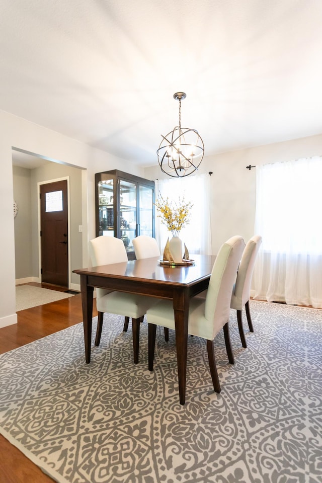6045 Galpin Lake Rd, Shorewood, MN 55331 - dining space featuring a chandelier and wood finished floors