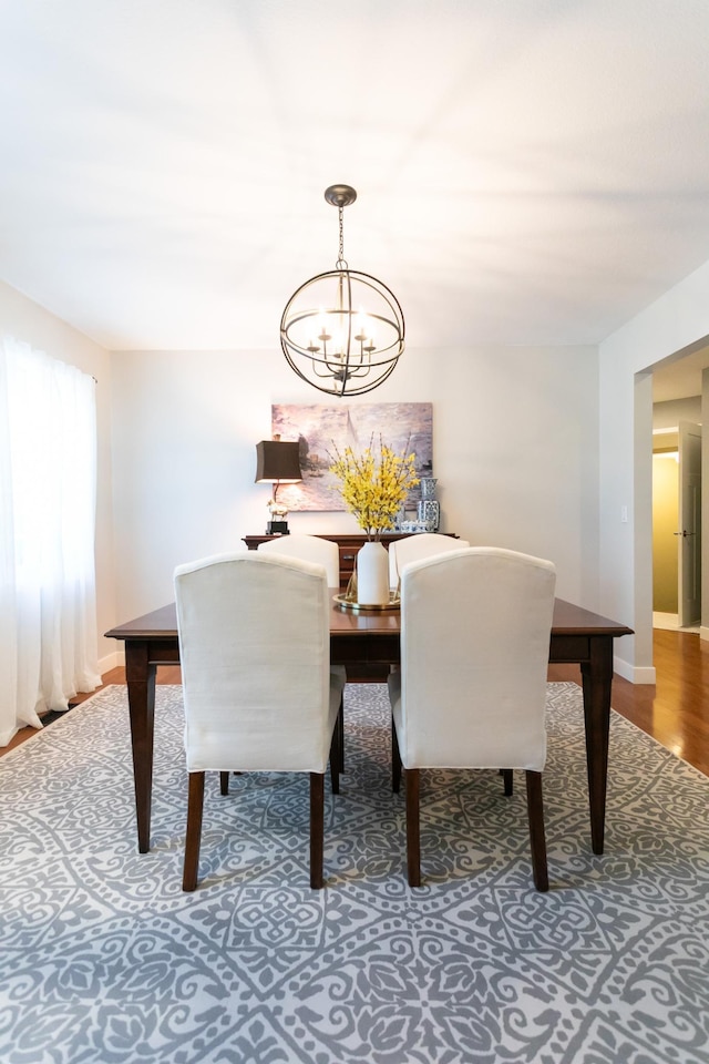 6045 Galpin Lake Rd, Shorewood, MN 55331 - dining area featuring a chandelier and wood finished floors