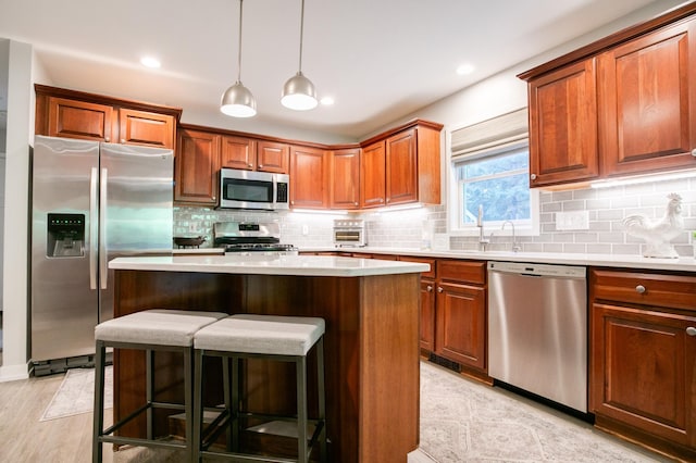 6045 Galpin Lake Rd, Shorewood, MN 55331 - kitchen with appliances with stainless steel finishes, light countertops, decorative backsplash, a kitchen island, and recessed lighting