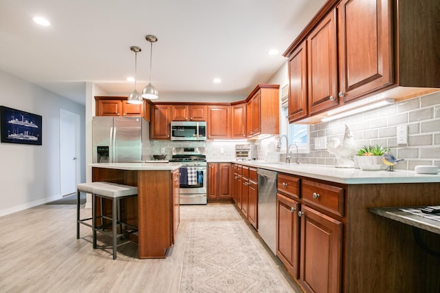 6045 Galpin Lake Rd, Shorewood, MN 55331 - kitchen featuring stainless steel appliances, a kitchen breakfast bar, backsplash, brown cabinets, and light wood finished floors