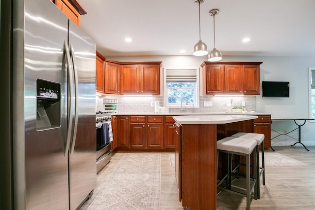 6045 Galpin Lake Rd, Shorewood, MN 55331 - kitchen with appliances with stainless steel finishes, brown cabinets, light countertops, light wood-style flooring, and recessed lighting