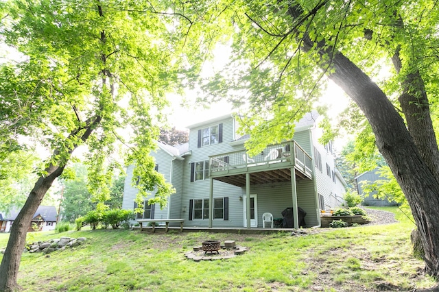 6045 Galpin Lake Rd, Shorewood, MN 55331 - rear view of property with a fire pit, a wooden deck, and a lawn