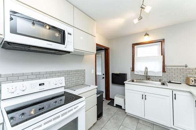 1130 4th Ave SE, Rochester, MN 55904 - kitchen featuring white appliances, tasteful backsplash, light countertops, and light tile patterned floors
