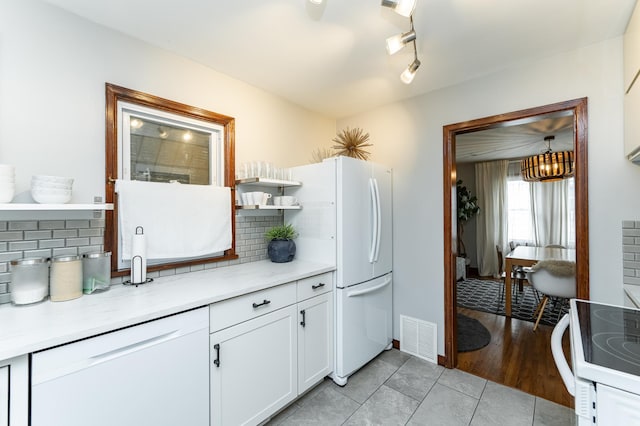 1130 4th Ave SE, Rochester, MN 55904 - kitchen featuring open shelves, white appliances, decorative backsplash, white cabinetry, and light tile patterned floors