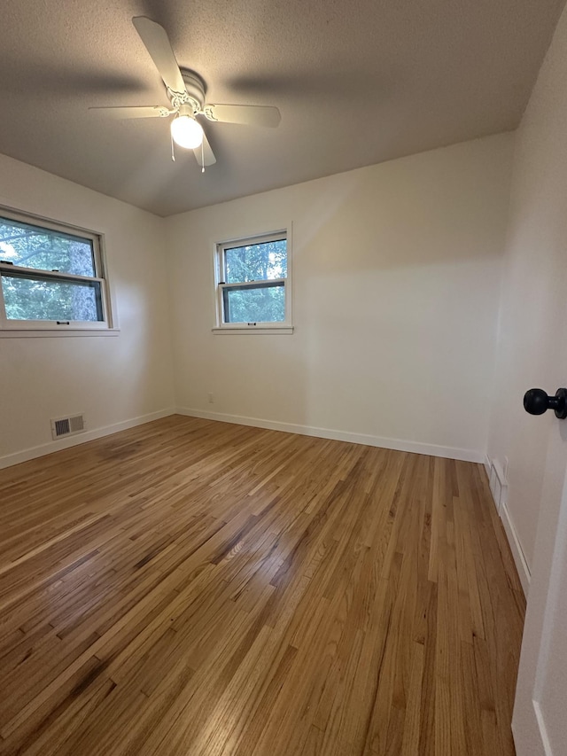 2325 Crosstown Blvd NE, Ham Lake, MN 55304 - unfurnished room featuring light wood finished floors and ceiling fan