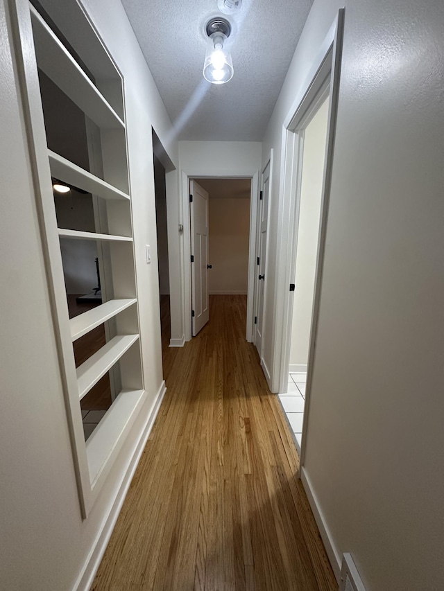 2325 Crosstown Blvd NE, Ham Lake, MN 55304 - hallway featuring wood finished floors and a textured ceiling