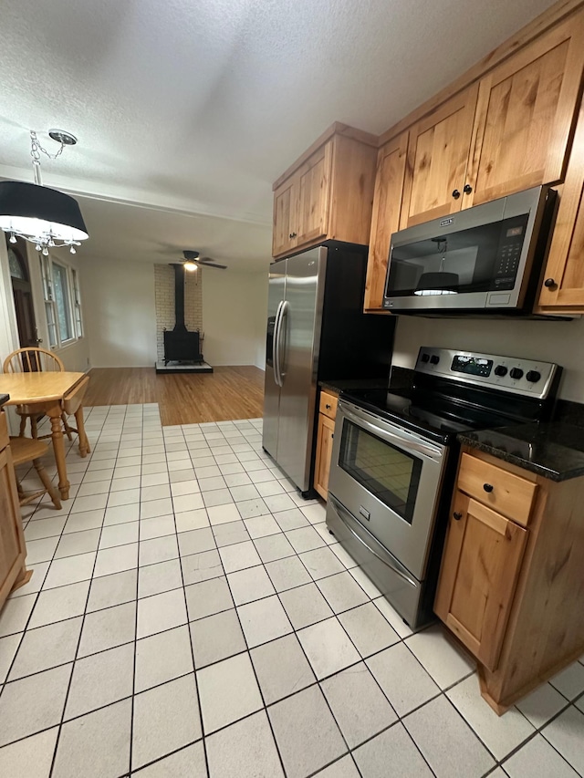 2325 Crosstown Blvd NE, Ham Lake, MN 55304 - kitchen with appliances with stainless steel finishes, dark countertops, a textured ceiling, open floor plan, and light tile patterned flooring