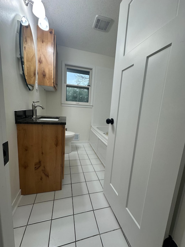 2325 Crosstown Blvd NE, Ham Lake, MN 55304 - full bath featuring tile patterned flooring, vanity, a bath, and a textured ceiling