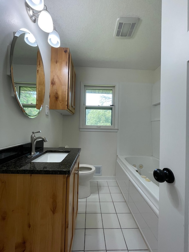 2325 Crosstown Blvd NE, Ham Lake, MN 55304 - full bath with vanity, a tub to relax in, tile patterned floors, and a textured ceiling