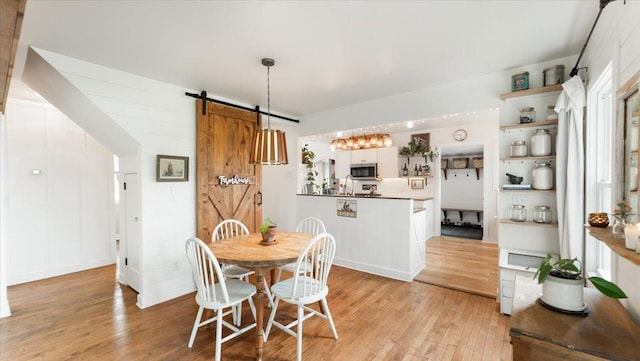 21038 Lace Ave, Hutchinson, MN 55350 - dining room featuring a barn door and light wood-type flooring