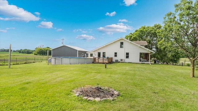21038 Lace Ave, Hutchinson, MN 55350 - back of property featuring an outdoor pool, a deck, and a fire pit