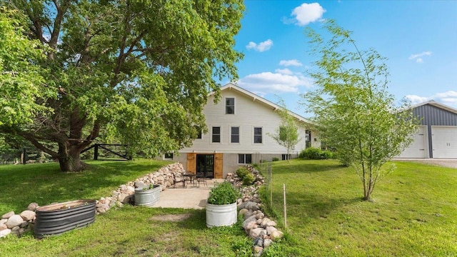 21038 Lace Ave, Hutchinson, MN 55350 - rear view of house with a lawn, a patio, and a garage