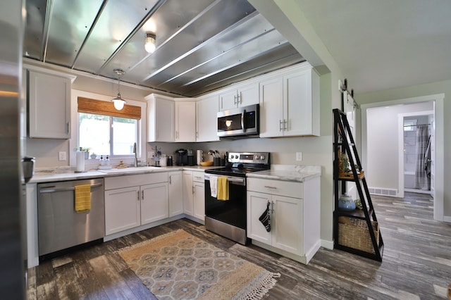 10032 Long Lake Rd, Brainerd, MN 56401 - kitchen featuring appliances with stainless steel finishes, light countertops, dark wood finished floors, and white cabinets