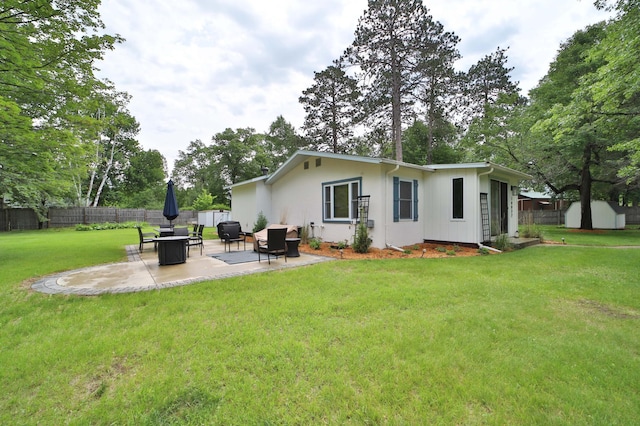 10032 Long Lake Rd, Brainerd, MN 56401 - rear view of house featuring a storage shed, a patio, and view of scattered trees