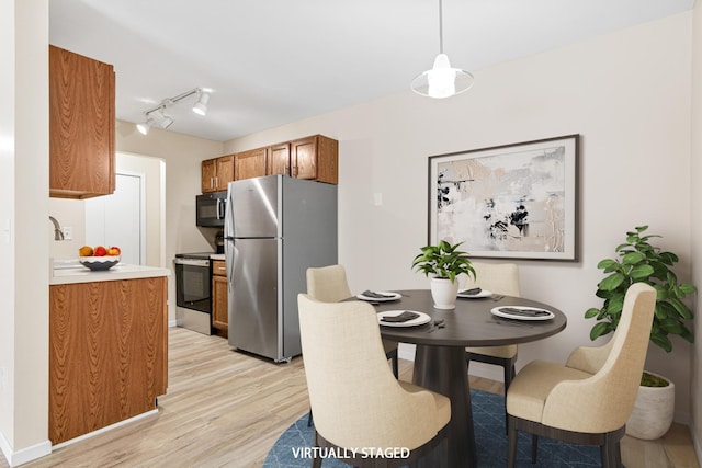 2801 Flag Ave N Unit 203, New Hope, MN 55427 - dining area featuring light wood finished floors and rail lighting