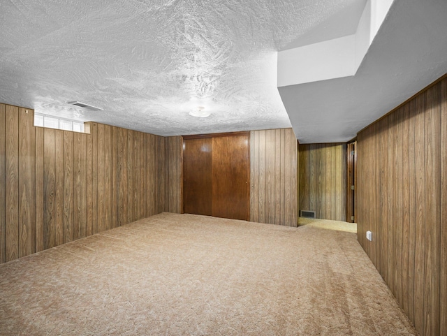 3945 8th Ave NW, Anoka, MN 55303 - basement with wooden walls, carpet flooring, and a textured ceiling