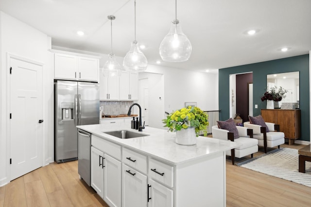 7579 Swan St, Lino Lakes, MN 55038 - kitchen featuring stainless steel appliances, backsplash, light wood-type flooring, white cabinets, and recessed lighting