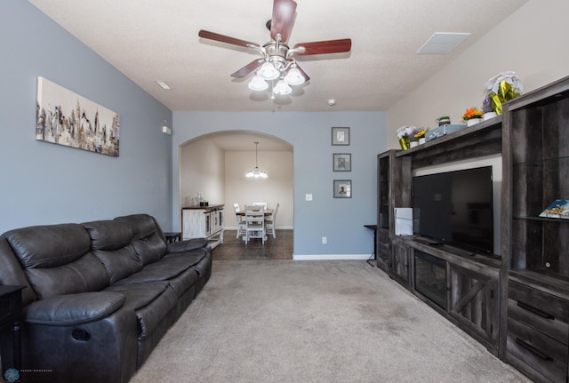 508 19th Ave W Unit C, West Fargo, ND 58078 - carpeted living room featuring arched walkways, a ceiling fan, and a chandelier