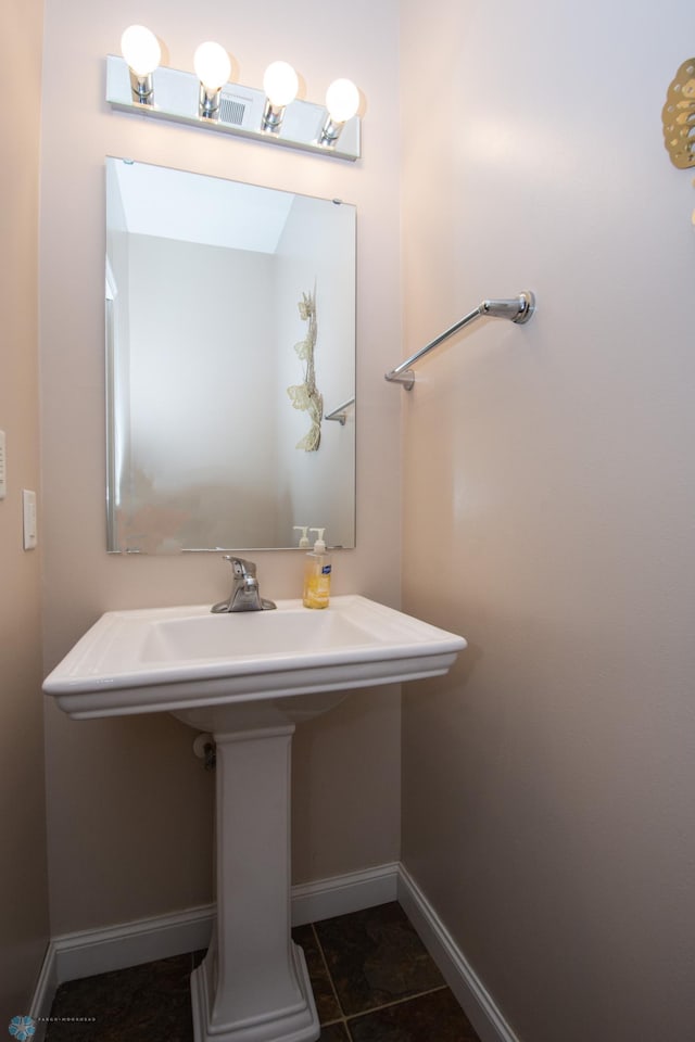 508 19th Ave W Unit C, West Fargo, ND 58078 - bathroom featuring baseboards and a sink