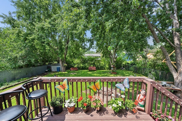1613 Lyn Curve Ave N, Minneapolis, MN 55411 - wooden deck featuring a fenced backyard and a storage shed