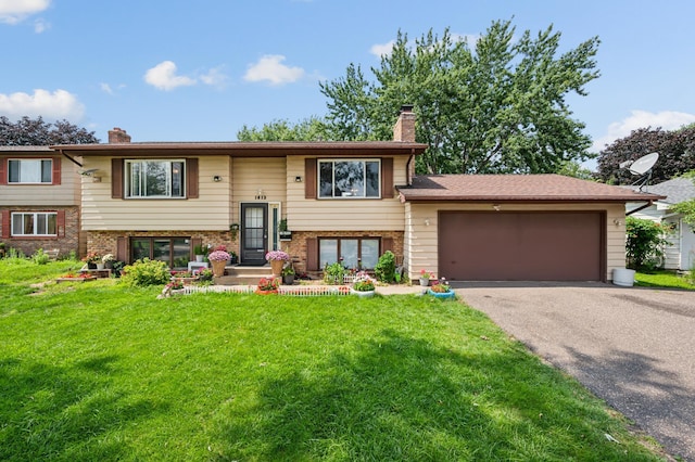1613 Lyn Curve Ave N, Minneapolis, MN 55411 - split foyer home featuring a chimney, a front yard, and asphalt driveway