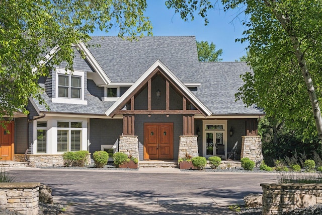 849 Brown Rd N, Orono, MN 55356 - view of front of home with roof with shingles, stone siding, and a porch