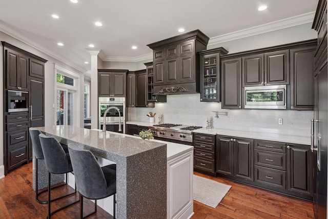 849 Brown Rd N, Orono, MN 55356 - kitchen with stainless steel appliances, dark wood-type flooring, tasteful backsplash, glass insert cabinets, and crown molding
