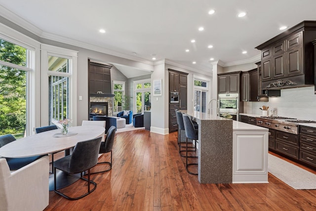 849 Brown Rd N, Orono, MN 55356 - kitchen featuring stainless steel appliances, healthy amount of natural light, a large fireplace, open floor plan, and recessed lighting
