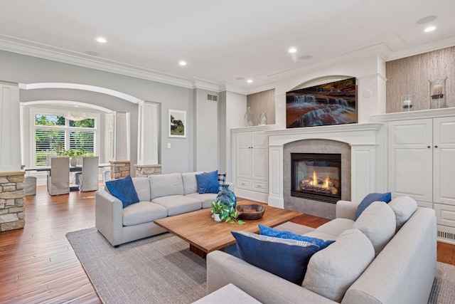 849 Brown Rd N, Orono, MN 55356 - living area with wood finished floors, crown molding, a glass covered fireplace, and recessed lighting