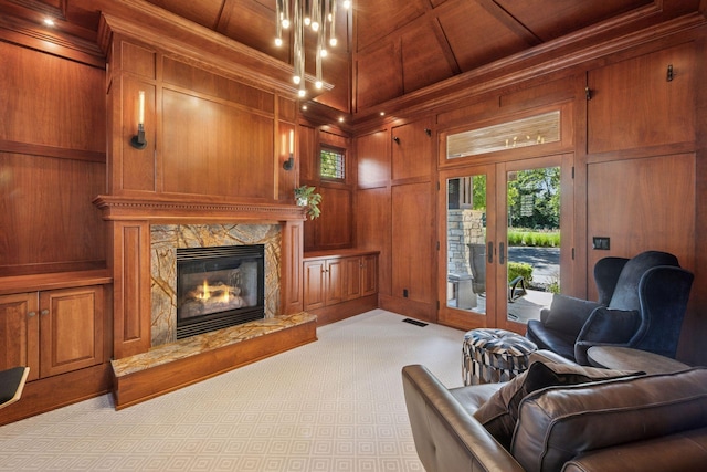 849 Brown Rd N, Orono, MN 55356 - living room featuring wood walls, light colored carpet, french doors, a high end fireplace, and wood ceiling