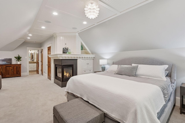 849 Brown Rd N, Orono, MN 55356 - bedroom with light colored carpet, vaulted ceiling, recessed lighting, a glass covered fireplace, and connected bathroom