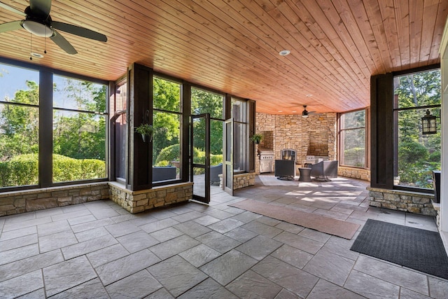 849 Brown Rd N, Orono, MN 55356 - unfurnished sunroom featuring ceiling fan, expansive windows, wood ceiling, and stone tile flooring