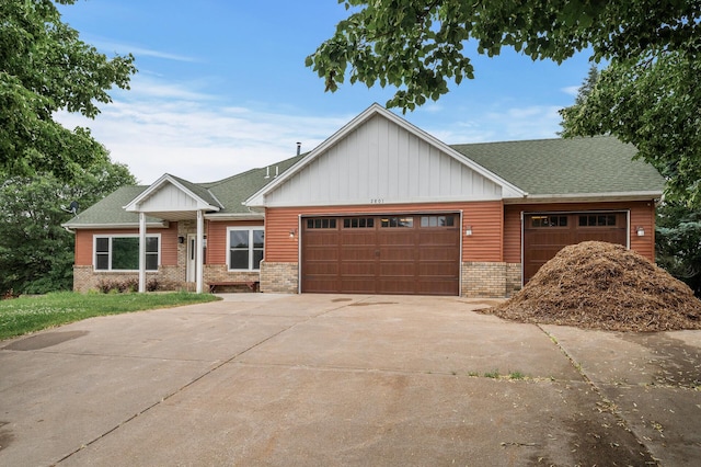 2801 263rd Ave NE, Isanti, MN 55040 - view of front of house featuring concrete driveway, a garage, board and batten siding, and brick siding