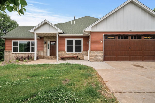 2801 263rd Ave NE, Isanti, MN 55040 - view of front facade featuring brick siding, an attached garage, concrete driveway, board and batten siding, and a front lawn