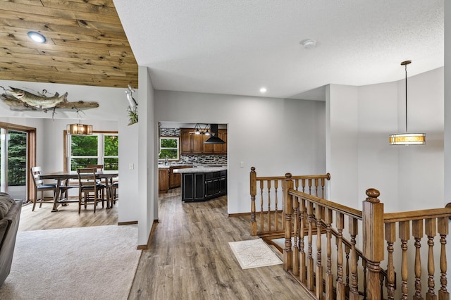 2801 263rd Ave NE, Isanti, MN 55040 - hall featuring an upstairs landing, wood finished floors, recessed lighting, and a textured ceiling