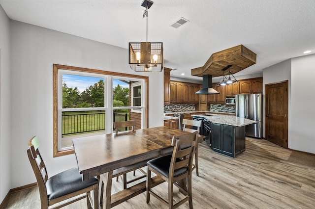 2801 263rd Ave NE, Isanti, MN 55040 - dining area featuring a chandelier, light wood finished floors, and recessed lighting
