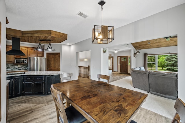 2801 263rd Ave NE, Isanti, MN 55040 - dining space featuring light wood-style flooring and a chandelier