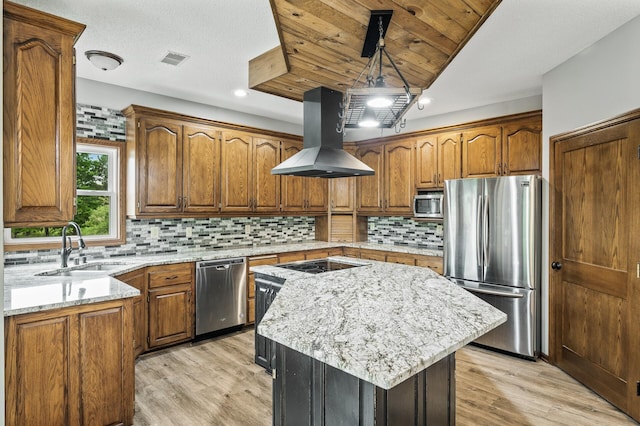 2801 263rd Ave NE, Isanti, MN 55040 - kitchen featuring stainless steel appliances, island range hood, a kitchen island, brown cabinetry, and light stone countertops