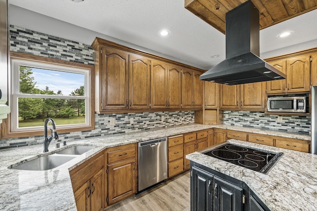 2801 263rd Ave NE, Isanti, MN 55040 - kitchen with island exhaust hood, appliances with stainless steel finishes, tasteful backsplash, light wood-style flooring, and a textured ceiling