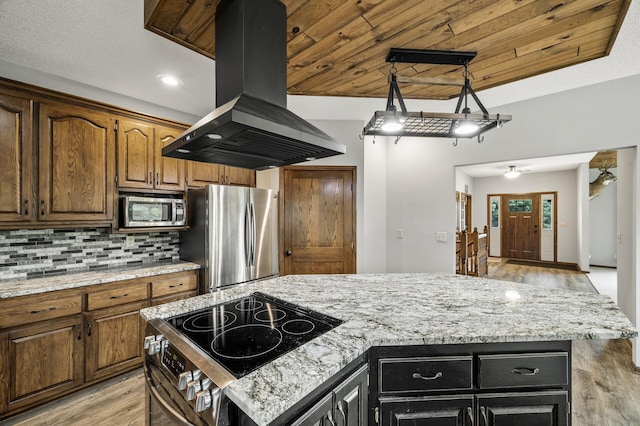 2801 263rd Ave NE, Isanti, MN 55040 - kitchen featuring island exhaust hood, appliances with stainless steel finishes, light wood-style floors, a kitchen island, and decorative backsplash