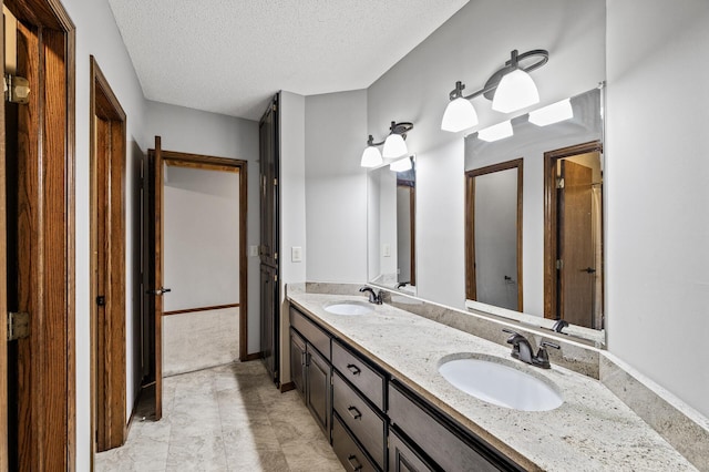 2801 263rd Ave NE, Isanti, MN 55040 - bathroom with double vanity and a textured ceiling