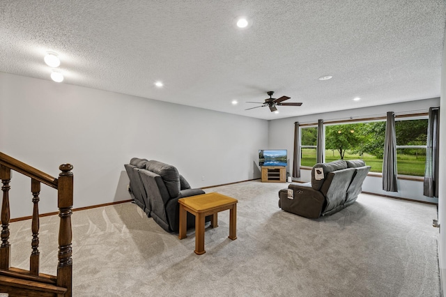 2801 263rd Ave NE, Isanti, MN 55040 - carpeted living room with recessed lighting, a textured ceiling, a ceiling fan, and stairs